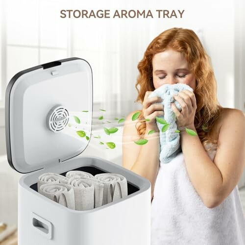 Woman enjoying scent from aroma tray with rolled towels.