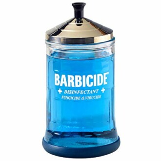 Barbicide disinfectant jar with blue liquid and silver lid