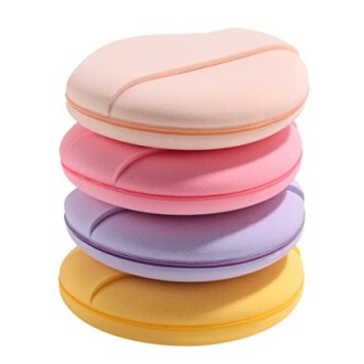 Stack of colorful round cushions in pastel shades.