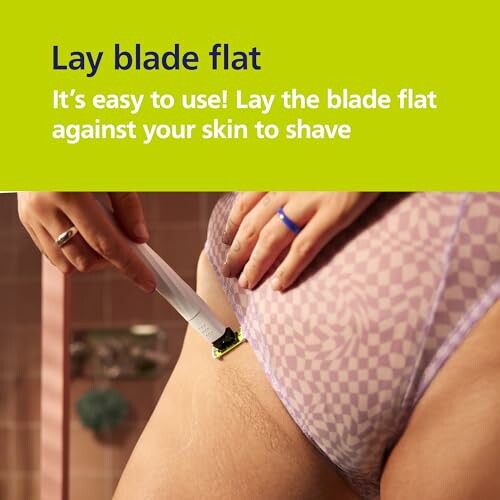 Person demonstrating how to lay a razor blade flat against skin for shaving.