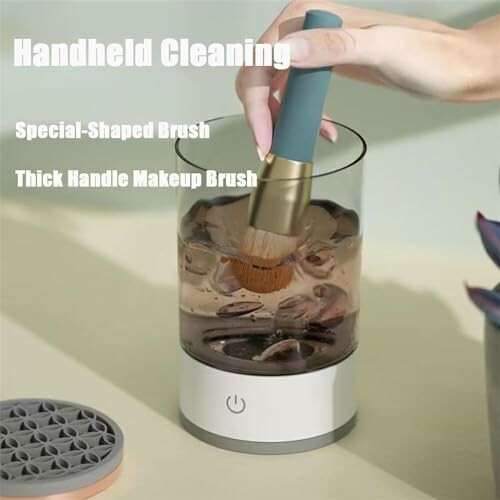 Hand cleaning device with a makeup brush being cleaned inside.