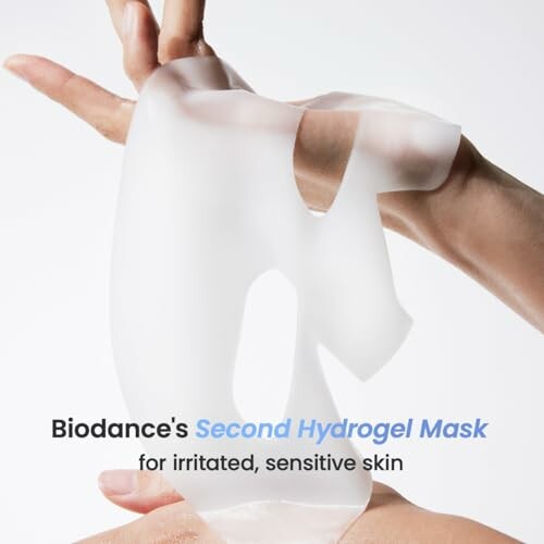 Hands holding a translucent hydrogel mask for sensitive skin.