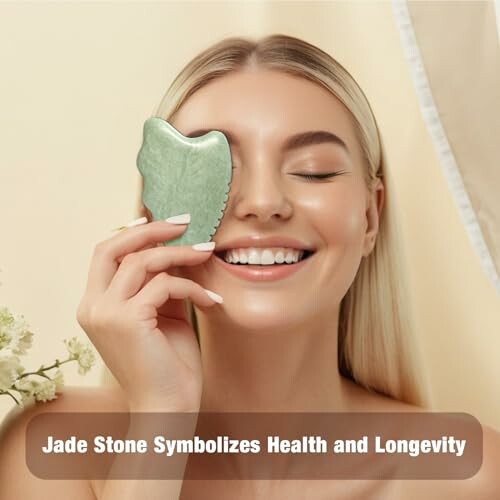 Woman using a jade stone facial tool.