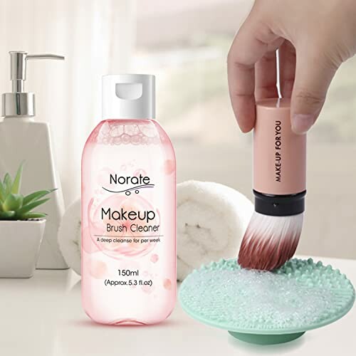 Makeup brush cleaner set with liquid, brush, and cleaning pad.