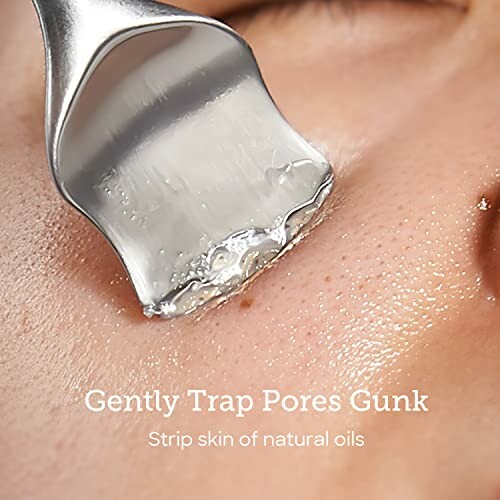 Close-up of a tool extracting gunk from skin pores.