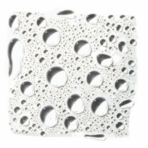 Close-up of water droplets on a white surface