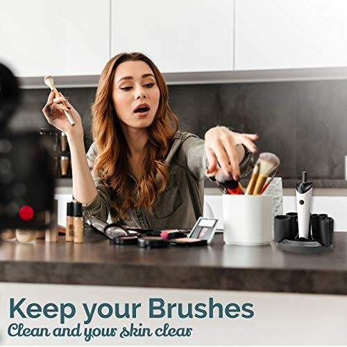 Woman using makeup brush cleaner on kitchen counter.